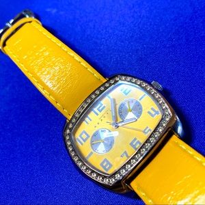 Silver Kenneth Cole Reaction yellow leather watch.